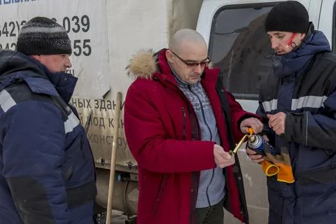 Three workers set up a gas burner Fotos Stock