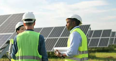 Three workers in special uniform discussing working moments outside. One woman Stock Footage 139507370