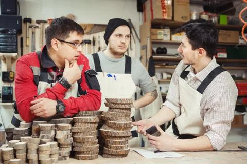 Three workers stipulated working process on wood threatment Stock Photos