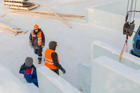 Three workers talking on the construction site 스톡 사진