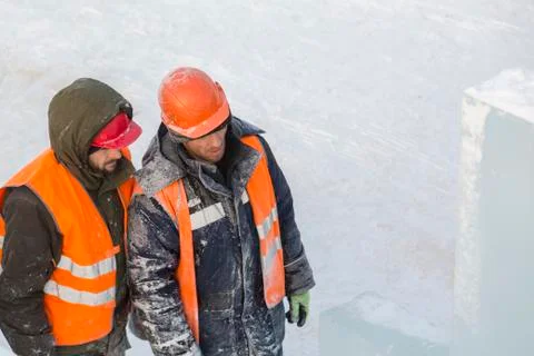 Three workers talking on the construction site 스톡 사진