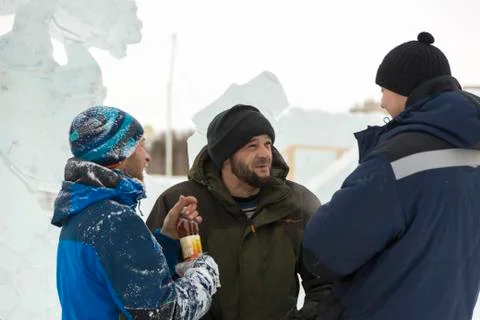Three workers talking on the construction site 스톡 사진
