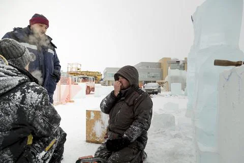 Three workers talking on the construction site Stock Photos
