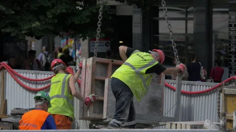 Three workers with vests working on the street in Prague Stock Footage 55881703