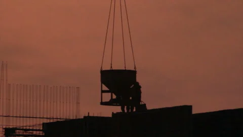 Three workers works with container with concrete delivered by crane Stock Footage 155436388