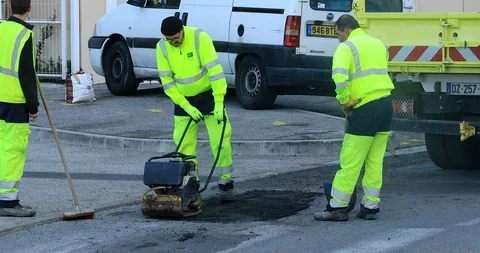 Three Workmen Repairing A Road Surface Stock-Footage 99377257