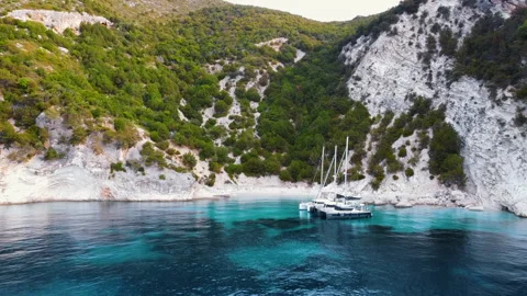 Three yachts anchoring in crystal clear turquoise water Stock Footage 151509178