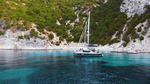 Three yachts anchoring in crystal clear turquoise water Video stock 151509342
