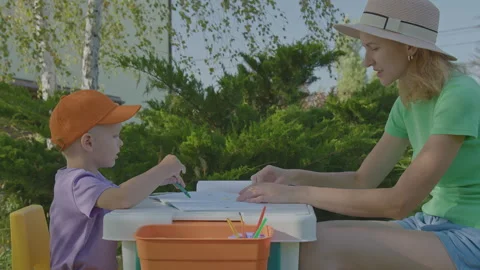 Three year old boy and his mother draw in home garden 1 Stock Footage 276891164
