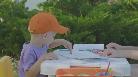 Three year old boy and his mother draw in home garden 3 Stock Footage 276898141