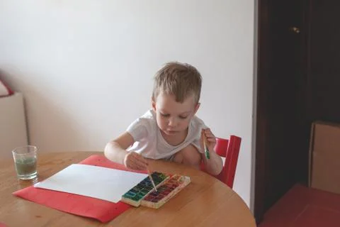Three year old boy paint with watercolor at home. Stock Photos