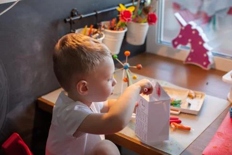 Three year old boy paint with watercolor at home. Stock Photos