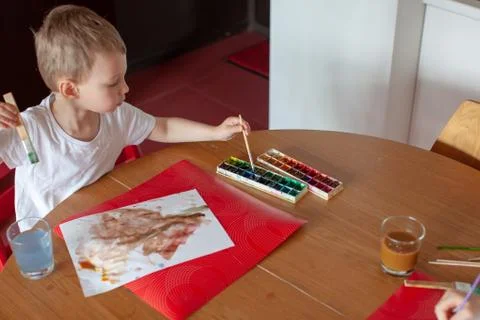 Three year old boy paint with watercolor at home. Stock Photos