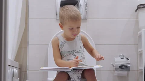 Three year old child learning to use the toilet. Stock Footage 296858257
