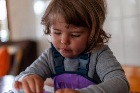 Three-year-old child solving a jigsaw puzzle at home Stock Photos