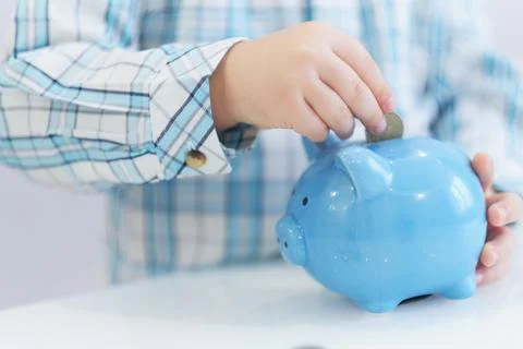 Three years old boy puts money in a piggy bank, piggybank concept. mantesori  스톡 사진