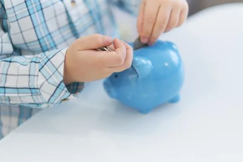 Three years old boy puts money in a piggy bank, piggybank concept. mantesori  스톡 사진