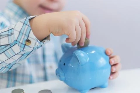 Three years old boy puts money in a piggy bank, piggybank concept. mantesori  스톡 사진