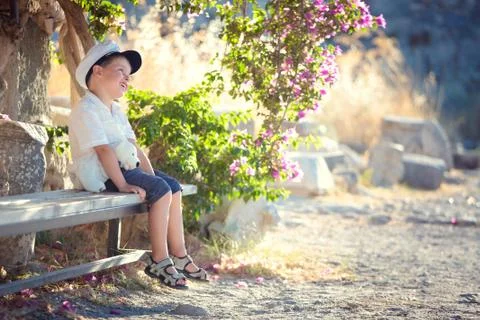 Three years old boy sitting on bench Stock Photos