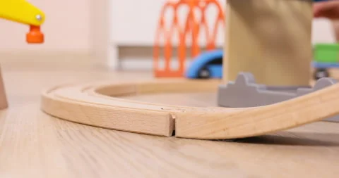 Three years old child boy play with wooden train, build toy railroad at home Stock Footage 96213569