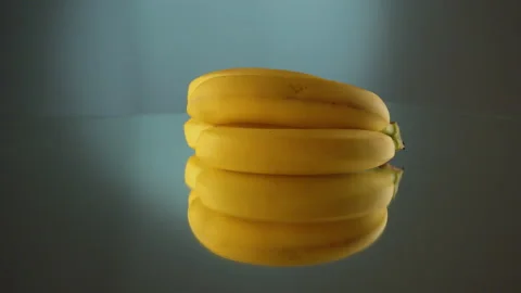 Three yellow bananas on turntable Stock Footage 171550167