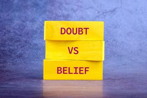 Three yellow blocks are stacked on top of each other with the words doubt and Stock Photos