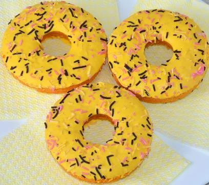 Three yellow donuts on the table Stock Photos