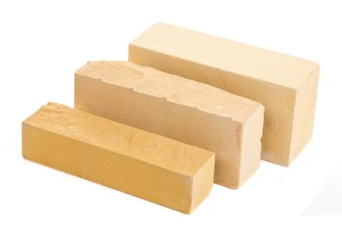 Three yellow long ceramic bricks at the white background, isolated Stock Photos