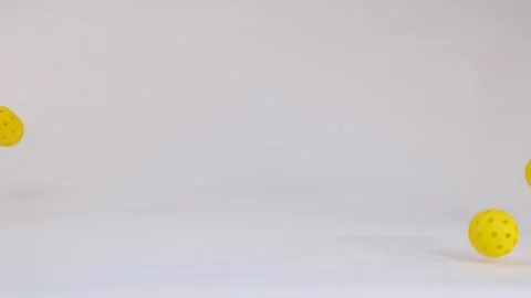 Three Yellow Pickleball Balls Falling and Bouncing on White Background 스톡 동영상 328069270
