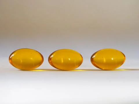 Three yellow pills Stock Photos