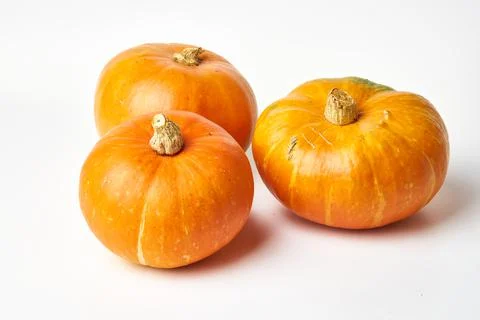 Three yellow pumpkins on a white background Stock Photos