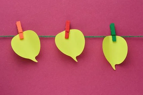 Three yellow thought cloud-shaped sticky notes attached to a rope with mult.. Stock Photos