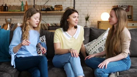 Three young active girlfriends dance disco and hop together, while having fun at Stock Footage 75614319