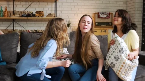 Three young active girlfriends dance disco and hop together, while having fun at Stock Footage 75668374