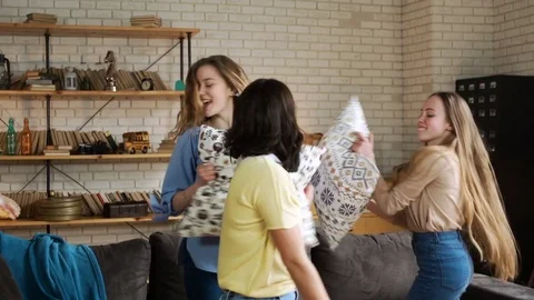 Three young active girlfriends dance disco and hop together, while having fun at Stock Footage 75669581