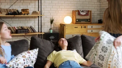 Three young active girlfriends dance disco and hop together, while having fun at Stock Footage 75670985