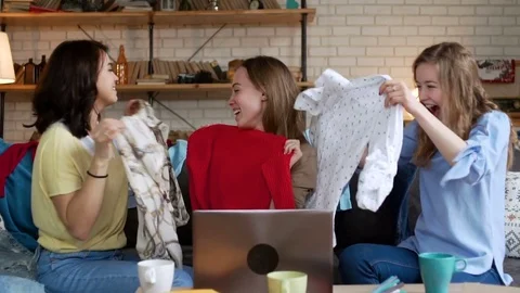 Three young active women make online payment for order by card while shopping Stock Footage 75963423