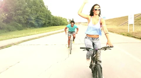 Three young adults having fun cycling on their bike, graded Stock Footage 59564865