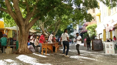 Three young African men dancing to street music in Greenmarket square Cape Town Stock Footage 85087948