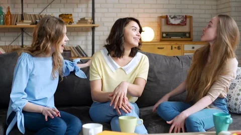 Three young and energetic best friend girls talk together emotionally and lively Stock Footage 74969871