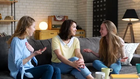 Three young and energetic best friend girls talk together emotionally and lively Stock Footage 74970155