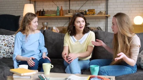 Three young and energetic best friend girls talk together emotionally and lively Stock Footage 74971398
