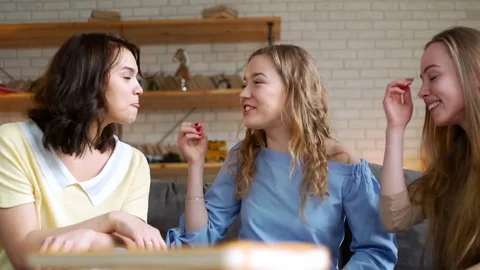 Three young and energetic best friend girls talk together emotionally and lively Видео 74993483