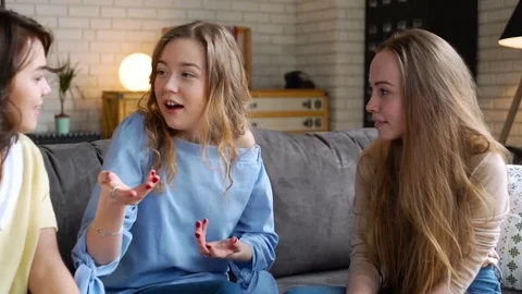 Three young and energetic best friend girls talk together emotionally and lively Video stock 74993575