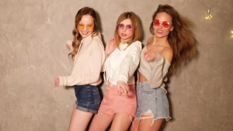 Three young beautiful smiling hipster girls in summer jeans shorts Stock Footage 140837046