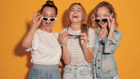 Three young beautiful smiling hipster girls in summer clothes Stock Footage 141841699