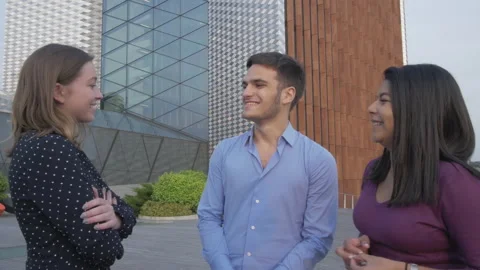 Three young colleagues discussing ideas outdoors Stock Footage 133104848