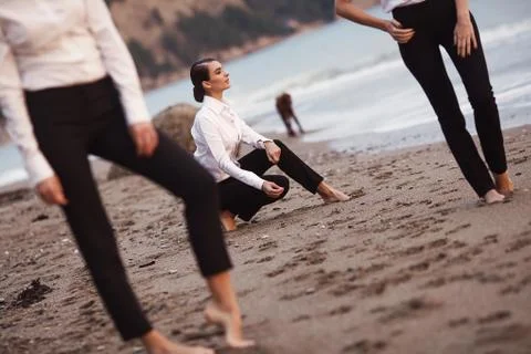 Three young dules on a sandy beach, against the sea. Stock Photos