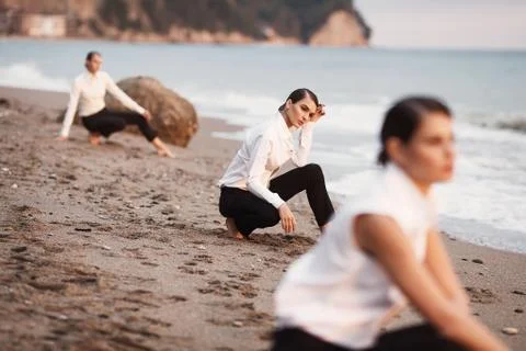 Three young dules on a sandy beach, against the sea. Stock Photos