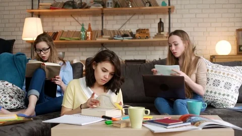 Three young female student study together being serious and concentrated Stock Footage 75963698